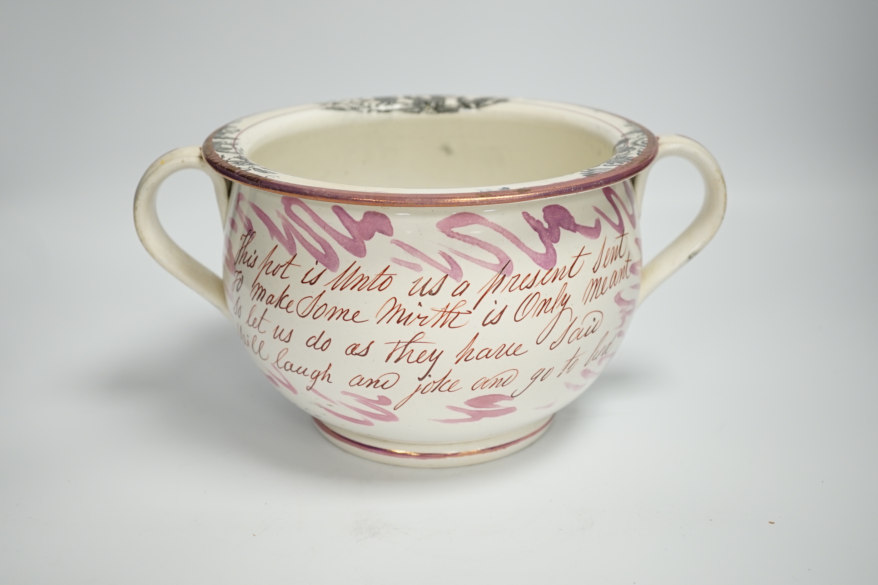 An early 19th century Sunderland or Tyneside pink lustre inscribed ’frog’ chamber pot, 14cm high